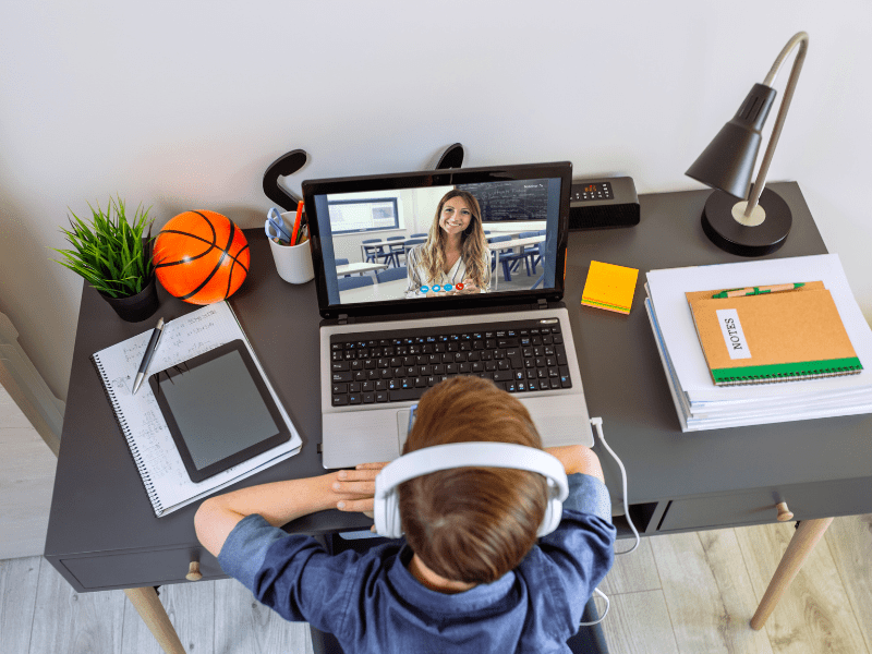 Kindergarten homeschool student attending an online class on a laptop