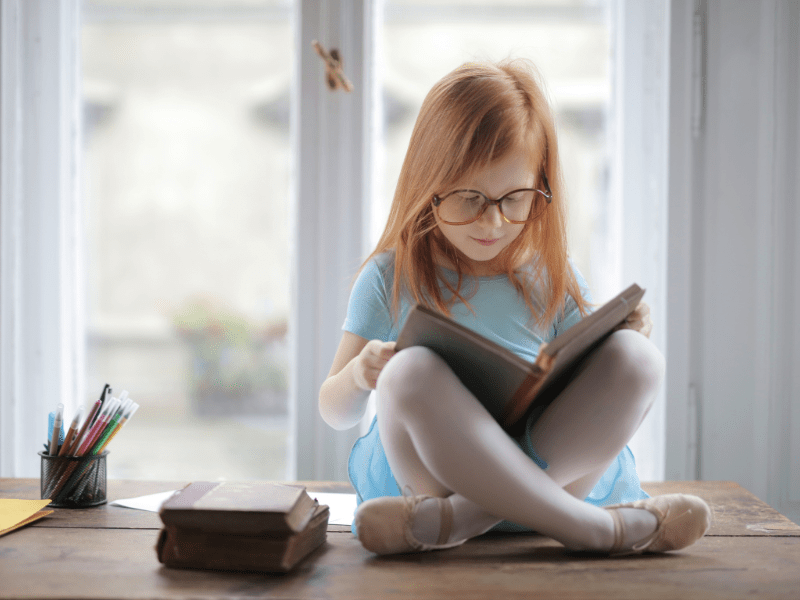 Child reading comfortably on a couch, illustrating relaxed deschooling activities in Florida homeschool